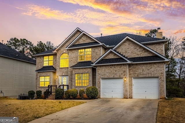 view of front of property featuring driveway, a chimney, roof with shingles, an attached garage, and a yard