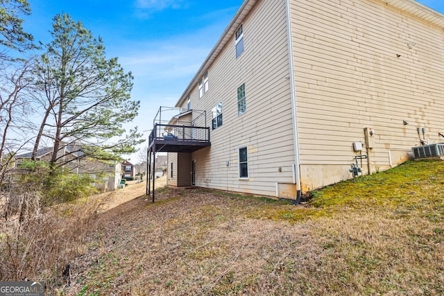 view of side of home with central AC unit