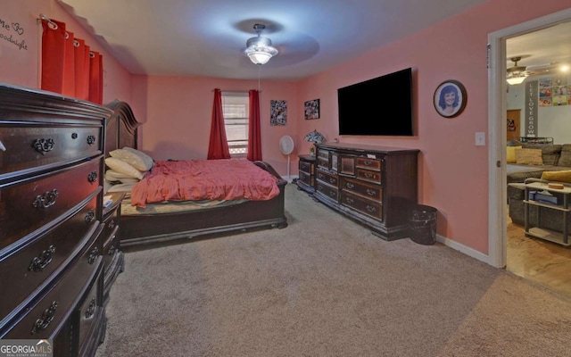 carpeted bedroom with ceiling fan and baseboards