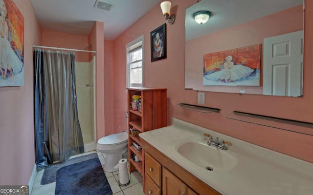 bathroom featuring toilet, a stall shower, visible vents, and vanity