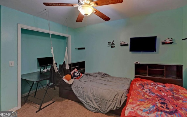 bedroom featuring light carpet, attic access, baseboards, and a ceiling fan