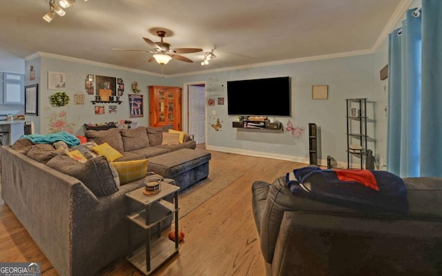 living area with light wood-style floors, crown molding, and ceiling fan