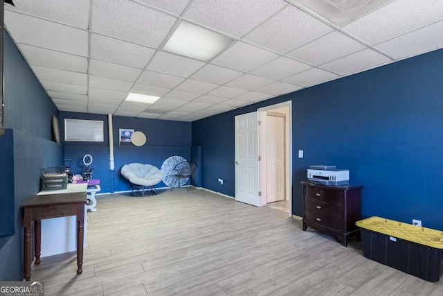 office space with wood finished floors and a paneled ceiling