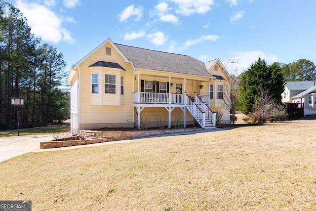 view of front of house featuring a porch, a front yard, and stairs