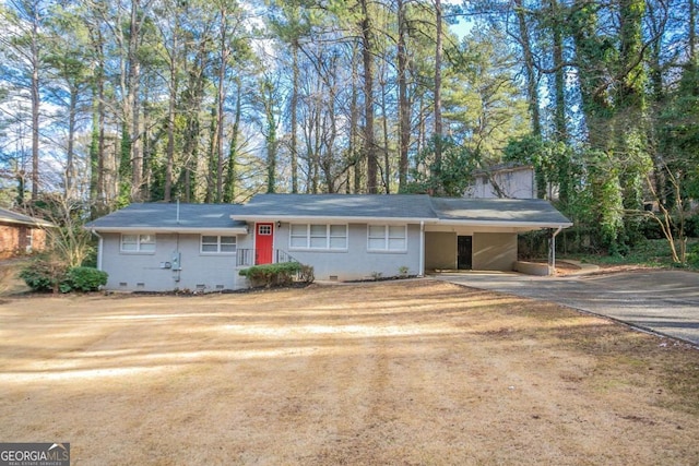 single story home featuring crawl space, driveway, and a carport