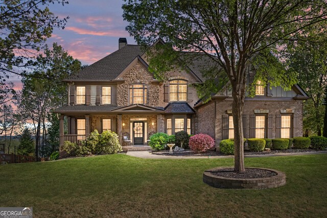 craftsman inspired home featuring a front lawn, a porch, and a chimney