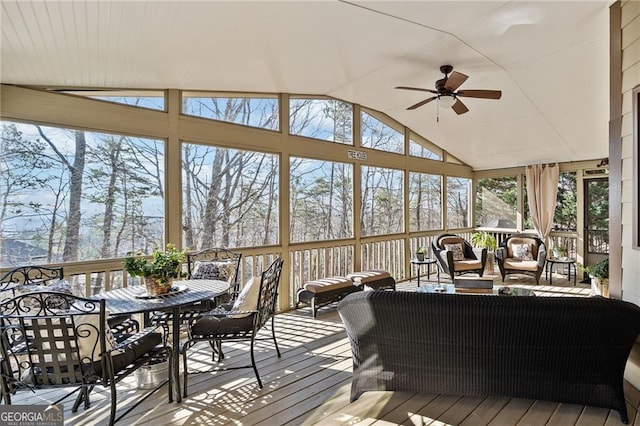 sunroom featuring a wealth of natural light, a ceiling fan, and vaulted ceiling