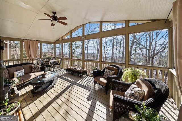 sunroom / solarium featuring plenty of natural light, ceiling fan, and vaulted ceiling