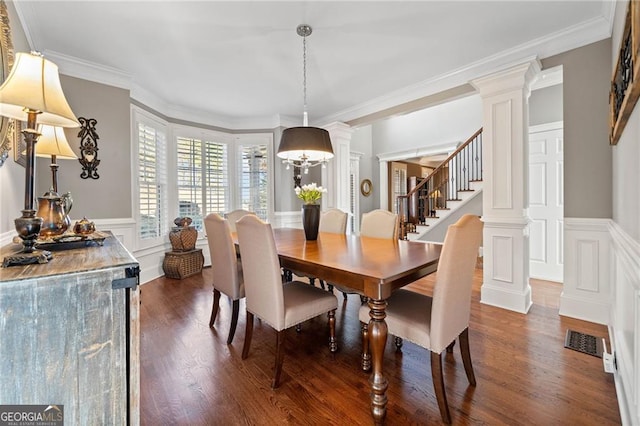 dining room featuring visible vents, ornate columns, dark wood-style flooring, stairs, and crown molding