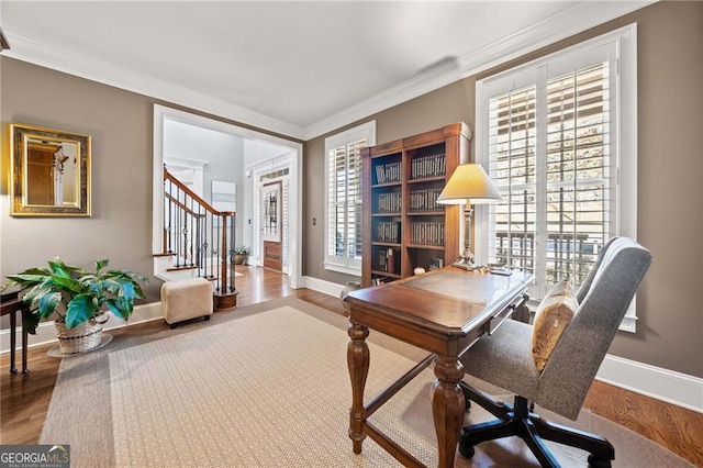 home office featuring baseboards, wood finished floors, and ornamental molding
