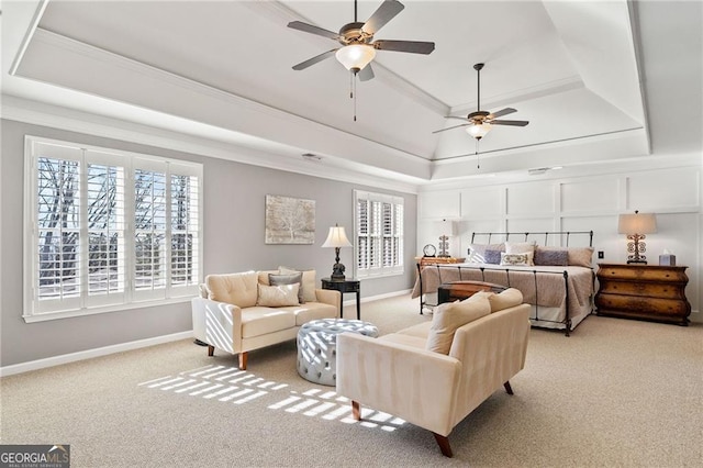 bedroom with a tray ceiling, carpet floors, baseboards, and ornamental molding