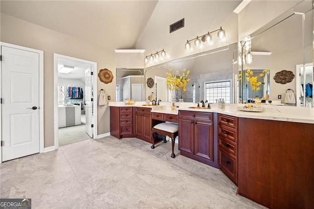 full bathroom featuring visible vents, high vaulted ceiling, a healthy amount of sunlight, and vanity