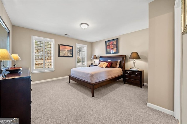 carpeted bedroom featuring visible vents and baseboards