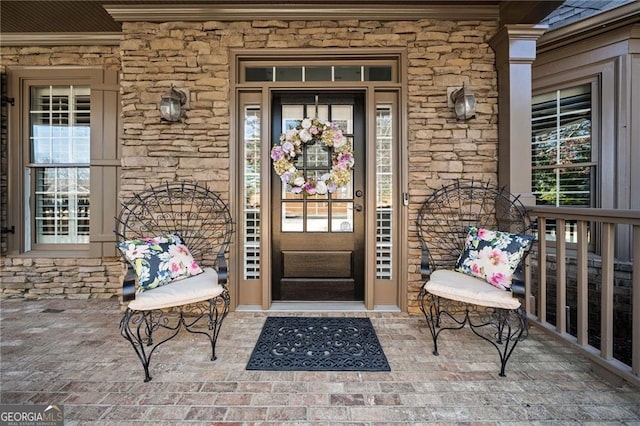 entrance to property featuring covered porch and stone siding