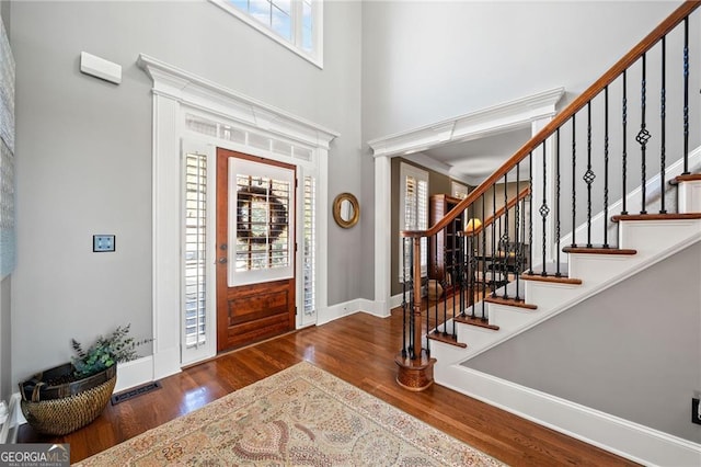 entrance to property featuring covered porch and stone siding