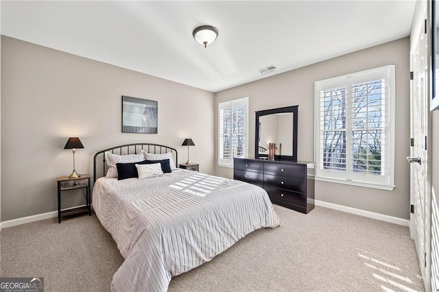 bedroom featuring multiple windows, carpet, and baseboards