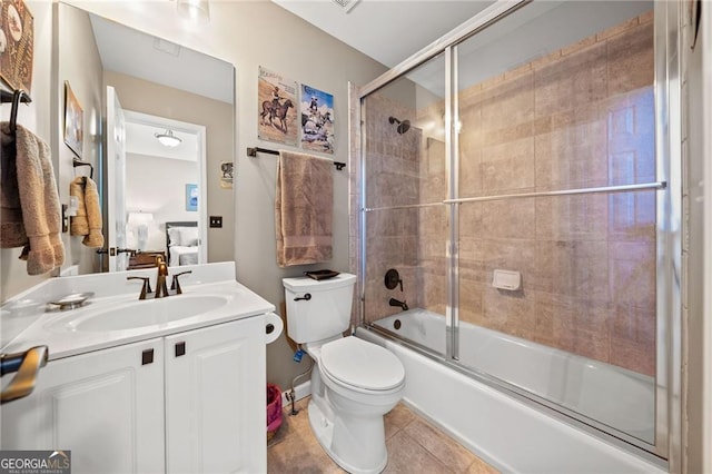 full bathroom with vanity, tile patterned floors, toilet, and combined bath / shower with glass door