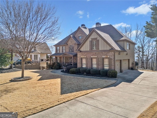 view of front of home featuring driveway, board and batten siding, an attached garage, brick siding, and a chimney