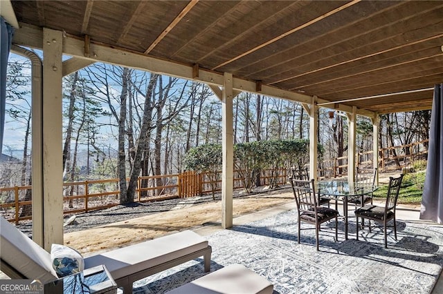 view of front of home featuring fence, covered porch, driveway, and a chimney