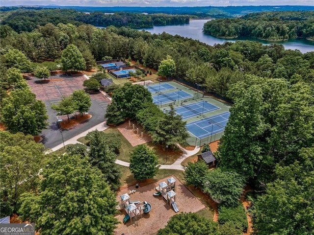 drone / aerial view featuring a view of trees and a water view