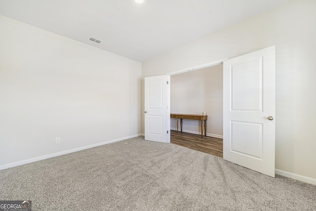 unfurnished bedroom with visible vents, baseboards, and carpet flooring