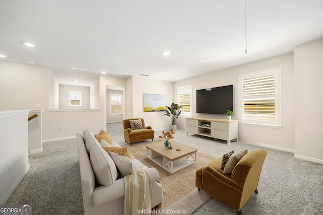 living room featuring light carpet, recessed lighting, and baseboards