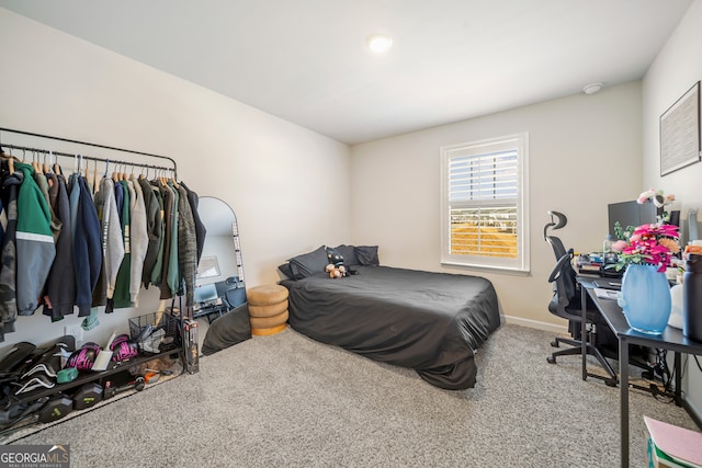 carpeted bedroom featuring baseboards