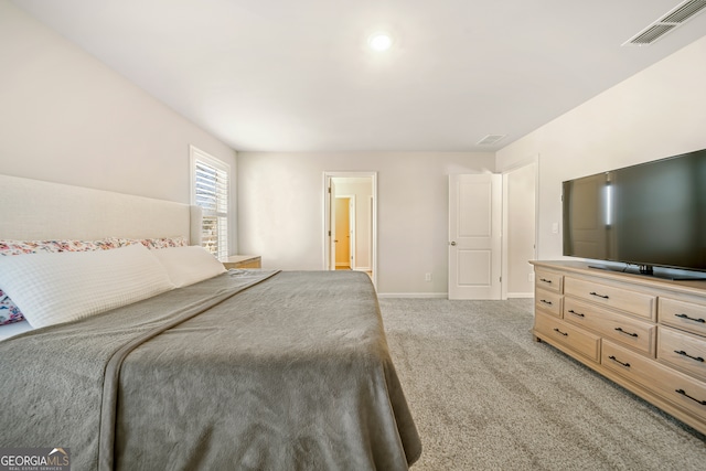 bedroom with visible vents, baseboards, and light colored carpet