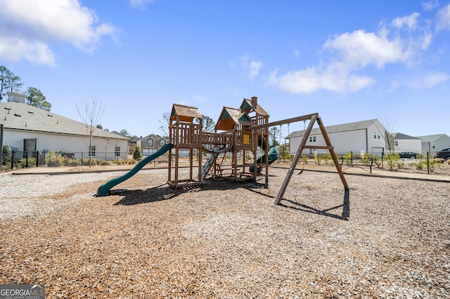 community jungle gym with a residential view and fence