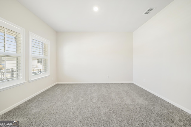 carpeted empty room with visible vents, recessed lighting, and baseboards