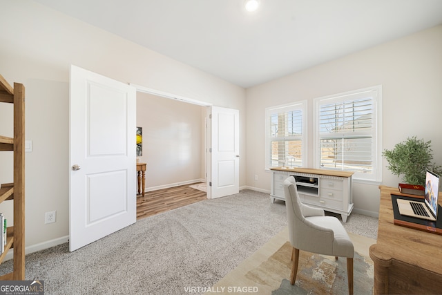 carpeted office with baseboards and lofted ceiling