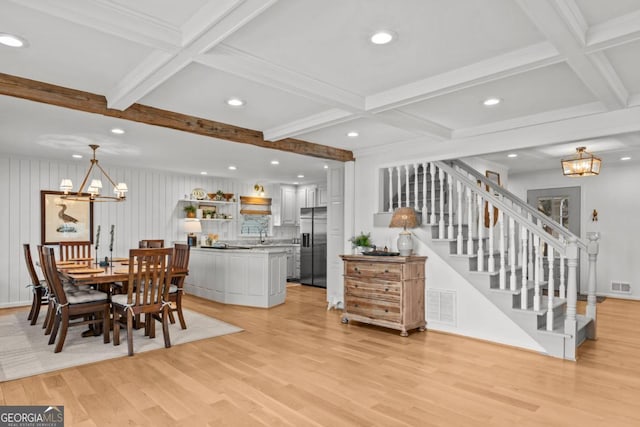 dining space featuring stairway, visible vents, and a notable chandelier