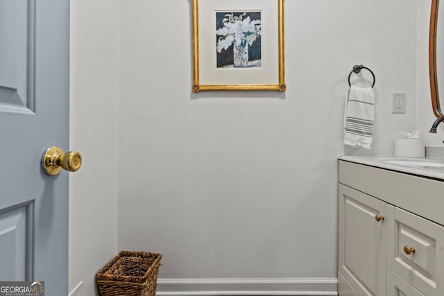 bathroom featuring baseboards and vanity