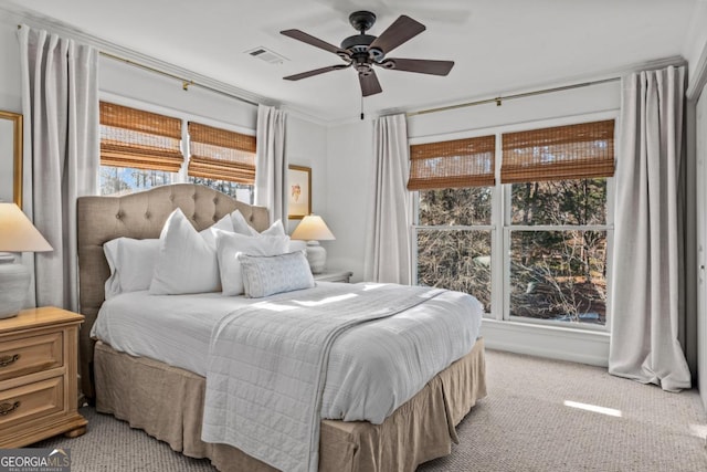 bedroom featuring light colored carpet, visible vents, and ceiling fan