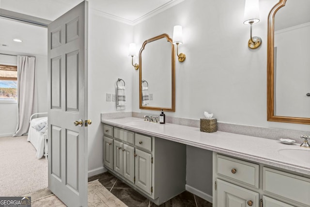 ensuite bathroom with crown molding, a sink, and ensuite bathroom