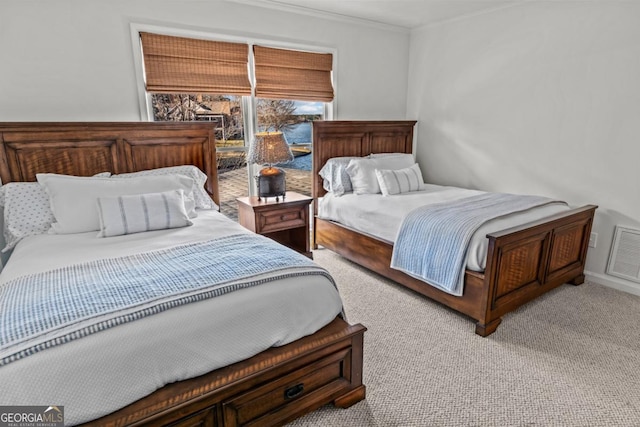 bedroom featuring ornamental molding, light colored carpet, and visible vents