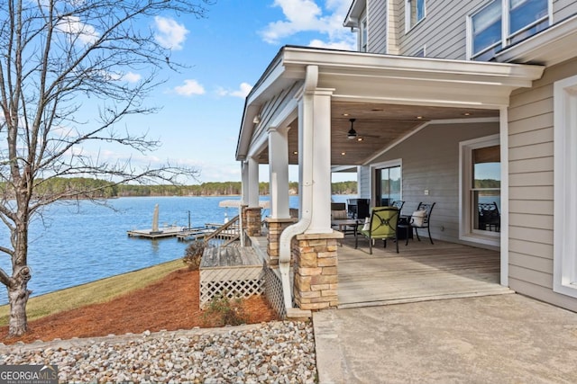 view of patio / terrace featuring a water view and a ceiling fan