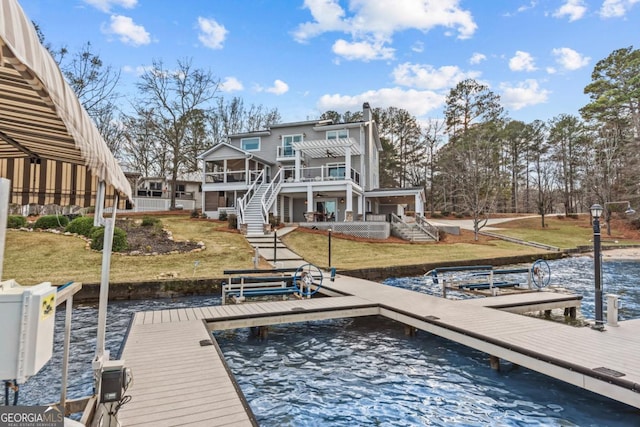 dock area with a water view, a lawn, stairway, and a pergola