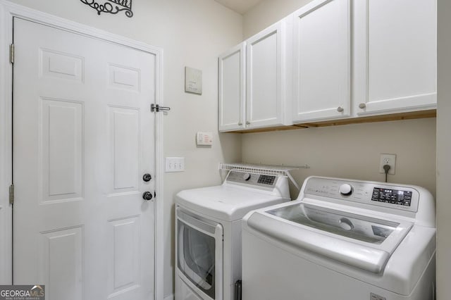 laundry area with cabinet space and independent washer and dryer