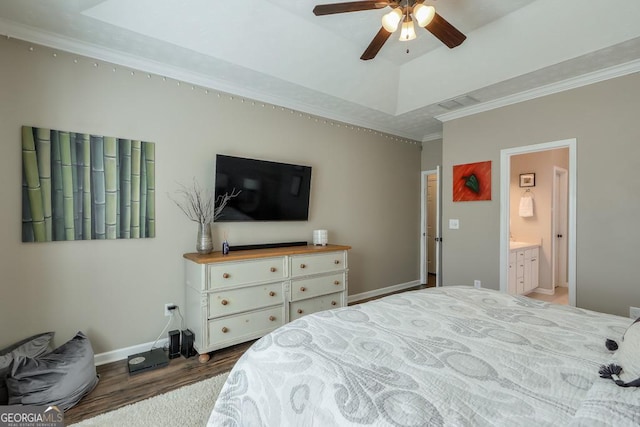 bedroom with baseboards, visible vents, dark wood finished floors, a tray ceiling, and crown molding