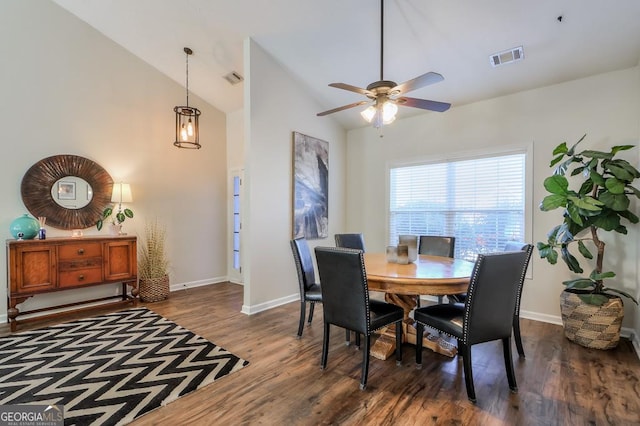 dining room with high vaulted ceiling, dark wood finished floors, visible vents, and baseboards