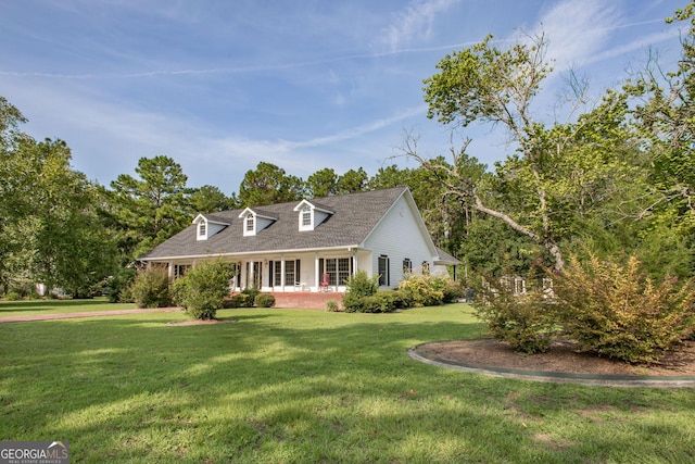 cape cod home with a front yard