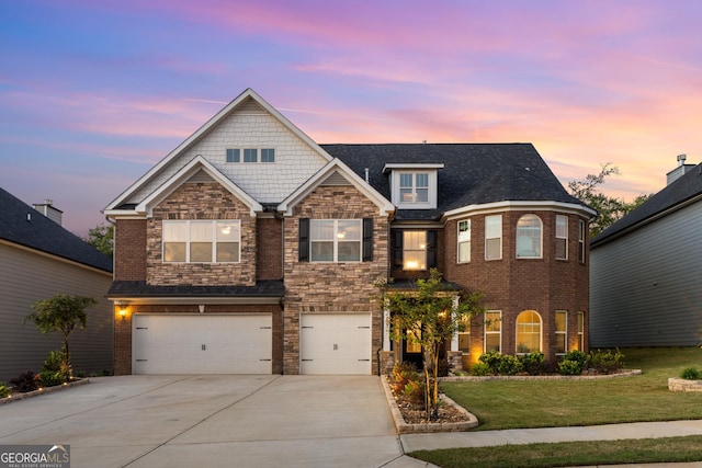 view of front of property featuring an attached garage, brick siding, driveway, a yard, and stone siding