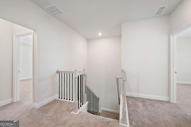 stairs featuring carpet floors, baseboards, visible vents, and recessed lighting