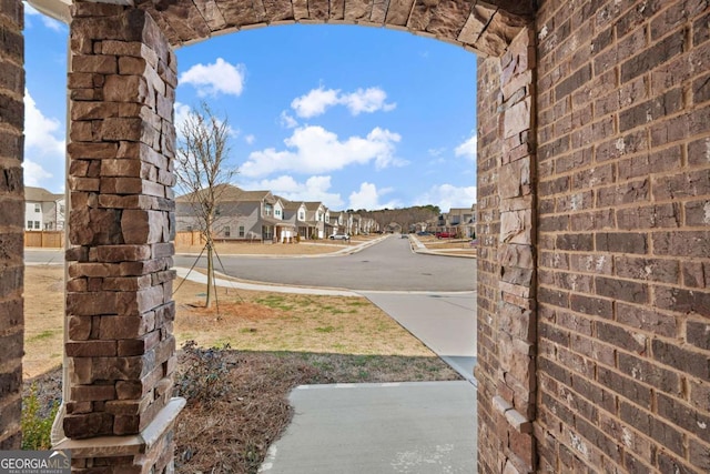 view of street with a residential view and curbs