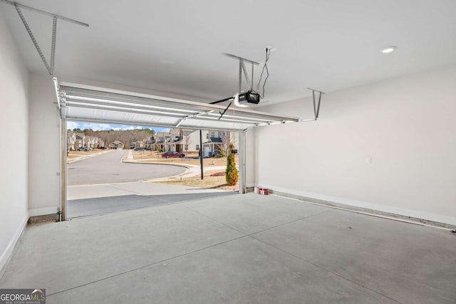 garage featuring baseboards and a garage door opener