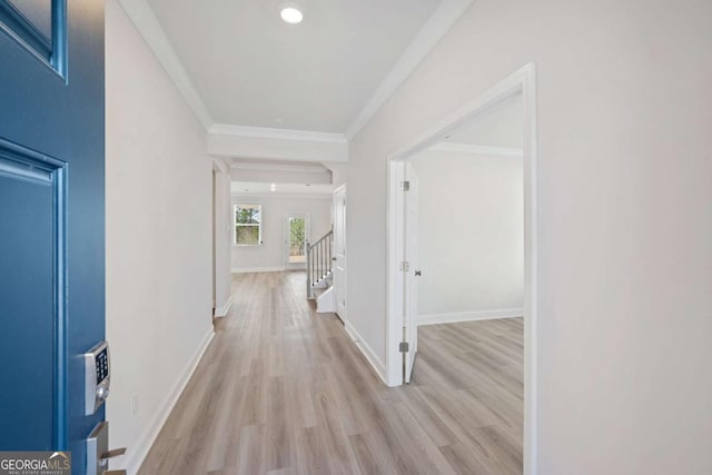 hallway featuring crown molding, recessed lighting, stairway, light wood-type flooring, and baseboards