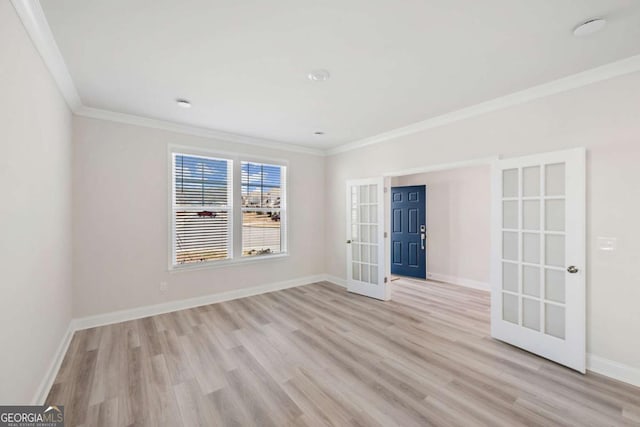 unfurnished room with light wood-type flooring, french doors, crown molding, and baseboards