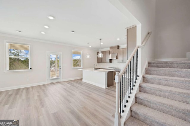 interior space featuring baseboards, light wood-style flooring, ornamental molding, stairs, and recessed lighting