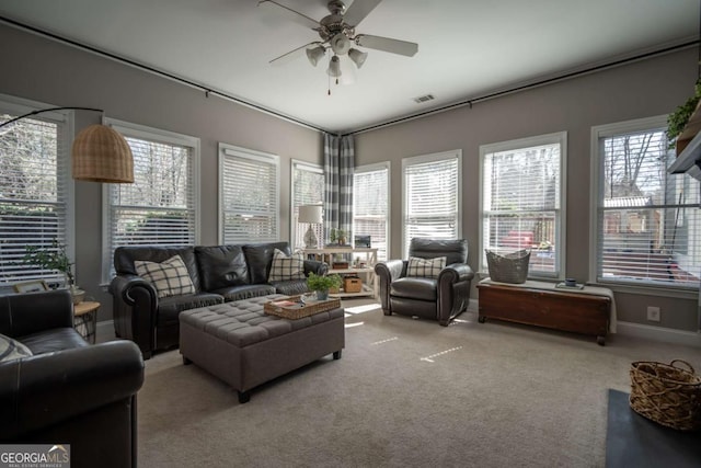 living room with carpet, plenty of natural light, baseboards, and a ceiling fan